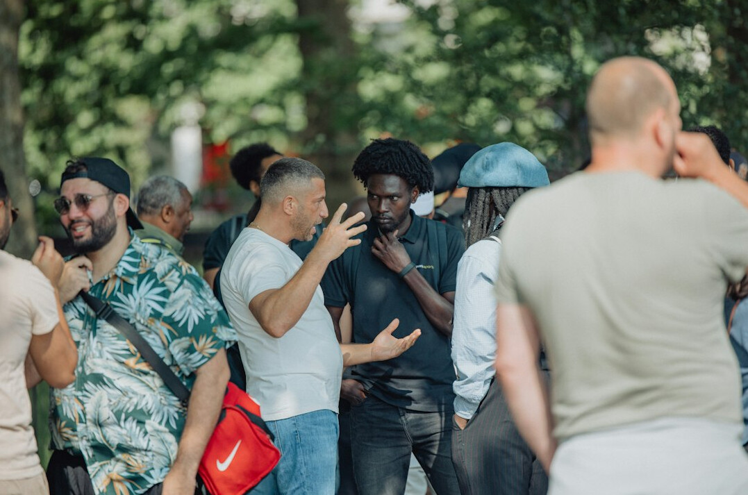 Diverse group of people having an open conversation outdoors