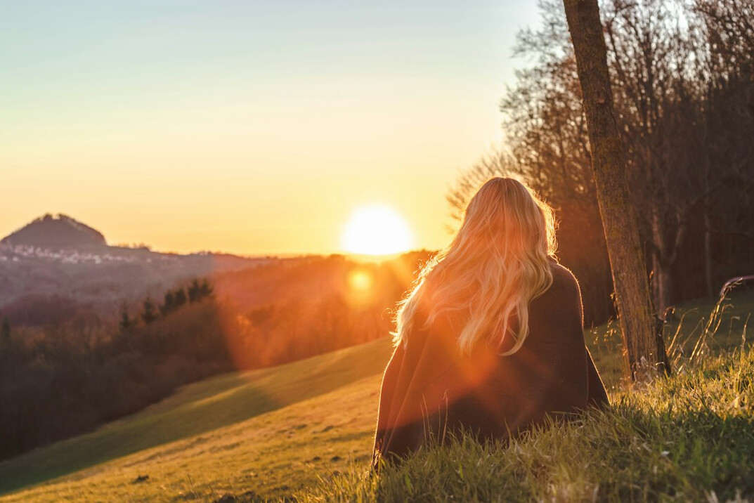 woman meditating at sunrise