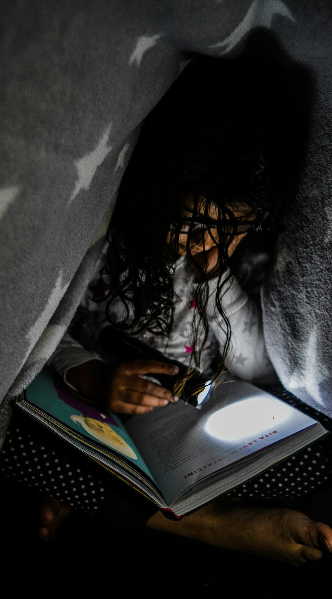 Woman writing personal goals in a notebook at night